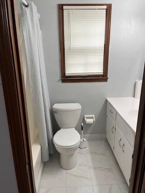 full bathroom with vanity, toilet, and shower / bath combo with shower curtain