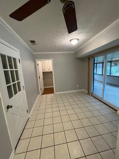 tiled spare room with crown molding