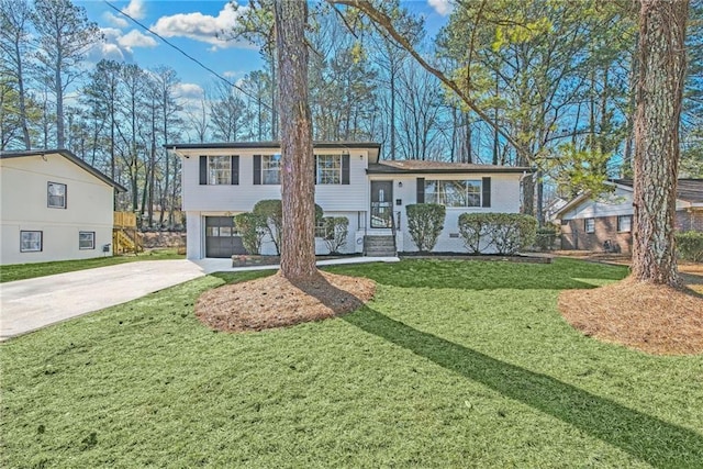 split level home with a garage and a front yard