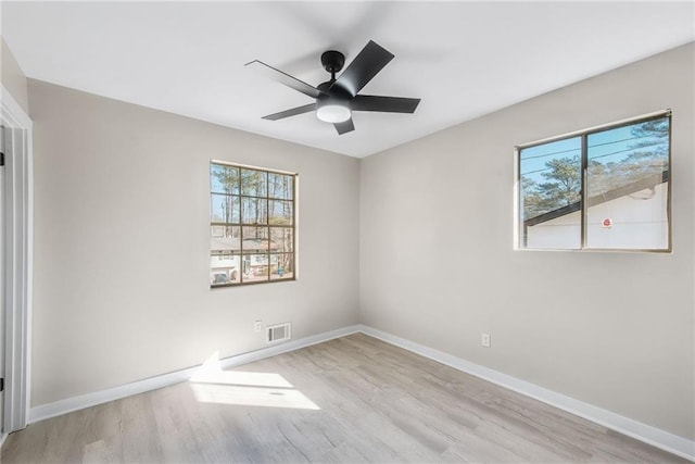 spare room with ceiling fan and light wood-type flooring