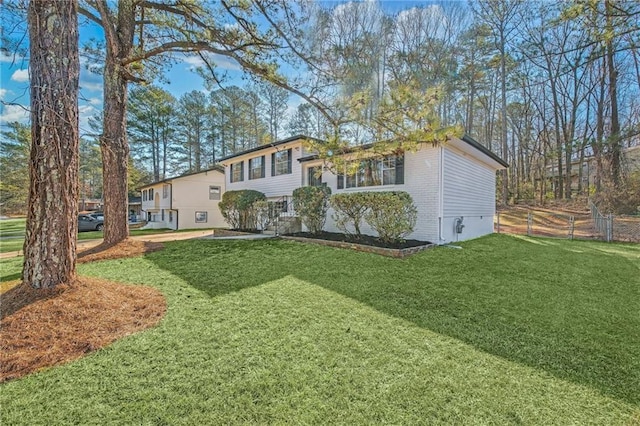 view of front of home with a garage and a front lawn