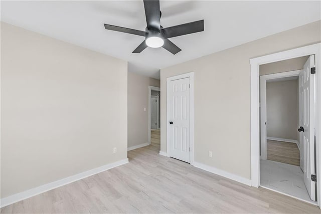 unfurnished bedroom featuring ceiling fan, a closet, and light wood-type flooring