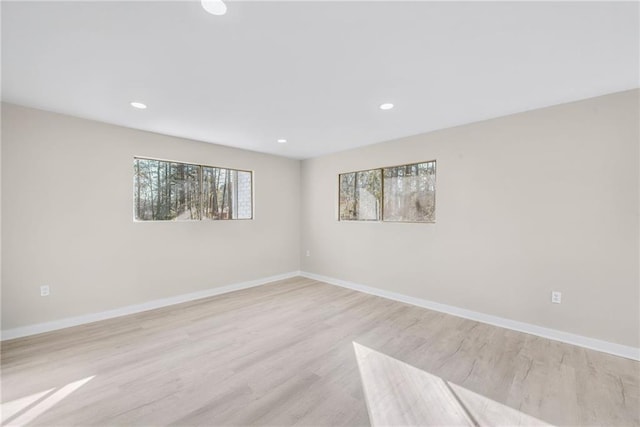 unfurnished room with light wood-type flooring