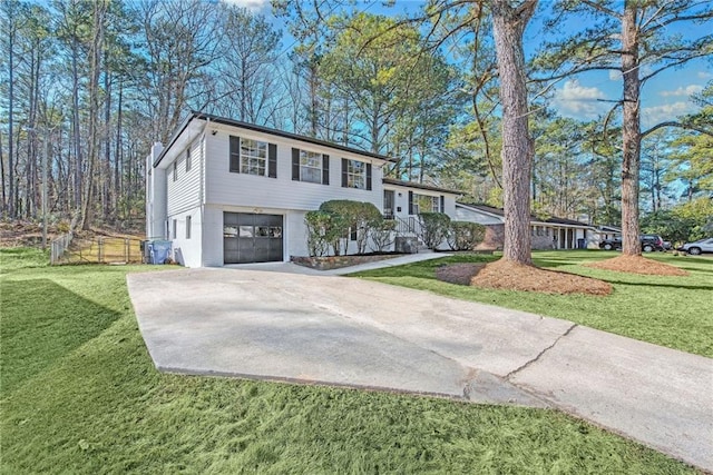 view of front of home with a garage and a front lawn