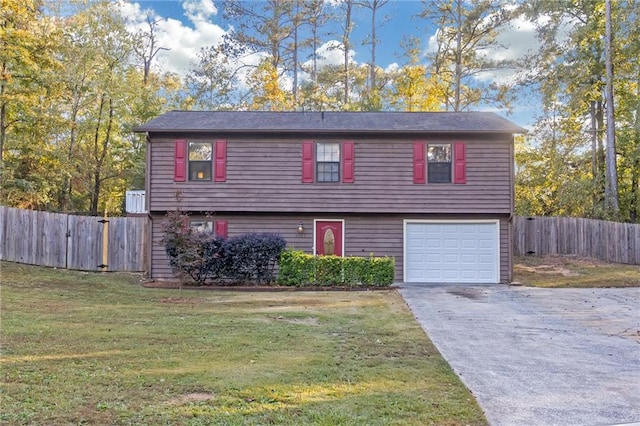 view of front of house featuring a garage and a front lawn