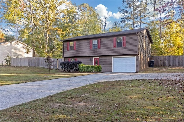 view of front of property featuring a garage and a front lawn