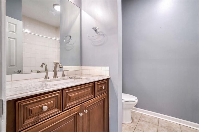 bathroom featuring tile patterned flooring, vanity, and toilet