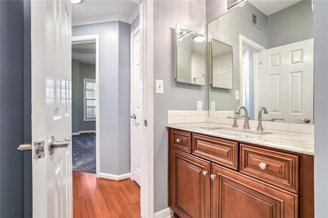 bathroom with vanity and hardwood / wood-style flooring