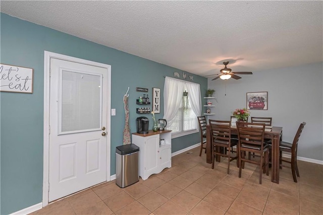 dining room featuring a ceiling fan, a textured ceiling, and light tile patterned flooring