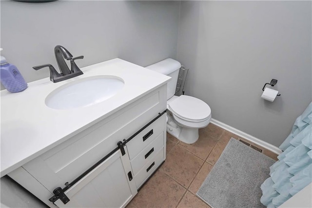bathroom with toilet, tile patterned floors, visible vents, and vanity