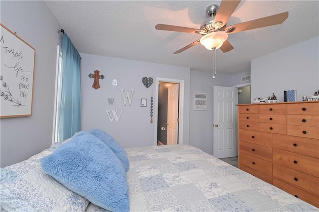 bedroom featuring a textured ceiling and ceiling fan