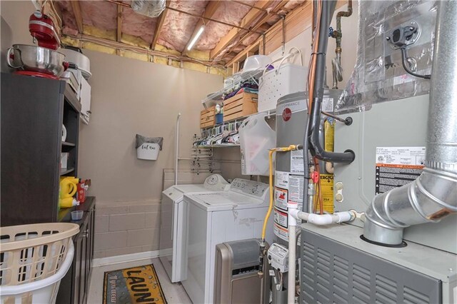 laundry area with washing machine and clothes dryer, laundry area, and heating unit