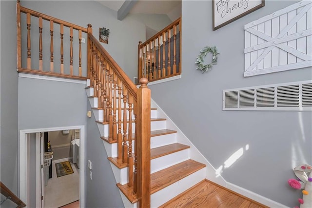 stairs with baseboards and wood finished floors