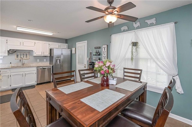 dining area with a ceiling fan, baseboards, and light tile patterned floors
