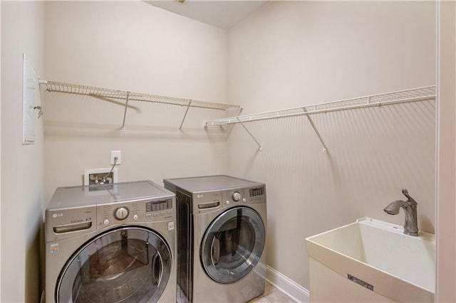 4321 Lanier Ridge Walk Unit 1704, Cumming, GA 30041 - clothes washing area with baseboards, washer and dryer, a sink, and laundry area