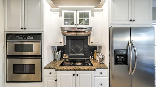 kitchen with white cabinetry, stainless steel appliances, backsplash, and exhaust hood