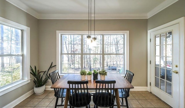 dining space featuring crown molding, light tile patterned flooring, baseboards, and a healthy amount of sunlight