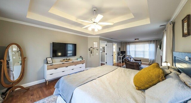bedroom with a ceiling fan, a raised ceiling, baseboards, and dark wood-style flooring