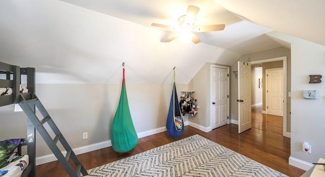 interior space featuring vaulted ceiling, ceiling fan, wood finished floors, and baseboards