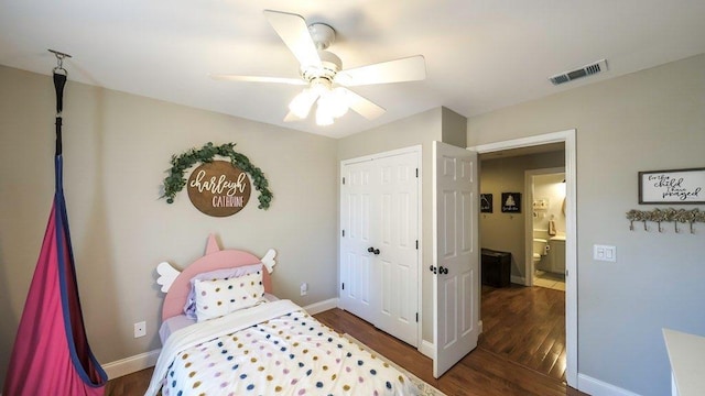 bedroom featuring baseboards, a closet, visible vents, and wood finished floors