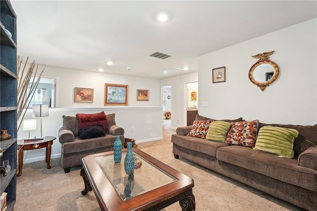 carpeted living area featuring visible vents, baseboards, attic access, and recessed lighting