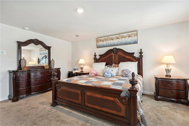 bedroom with light colored carpet, visible vents, and baseboards