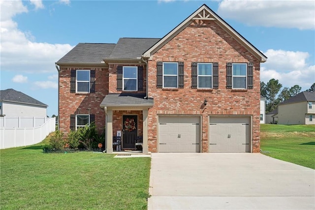 view of front facade featuring driveway, brick siding, fence, and a front yard