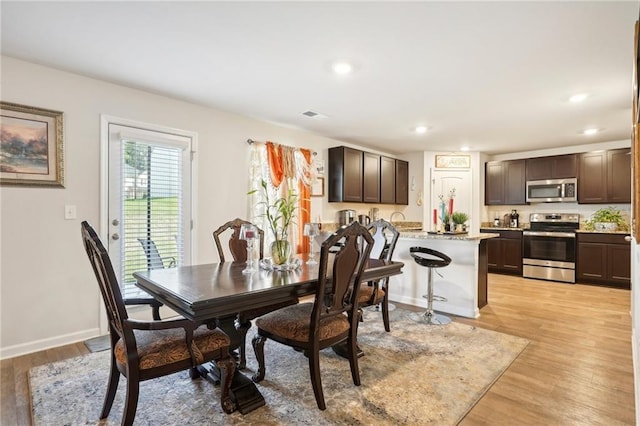 dining space with light wood-style floors, recessed lighting, visible vents, and baseboards