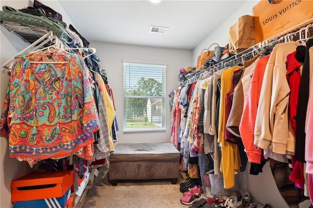 walk in closet featuring visible vents and carpet flooring