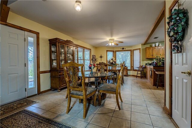 tiled dining room featuring ceiling fan