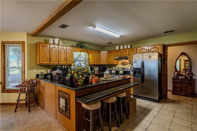 tiled dining area featuring wooden walls, high vaulted ceiling, and ceiling fan