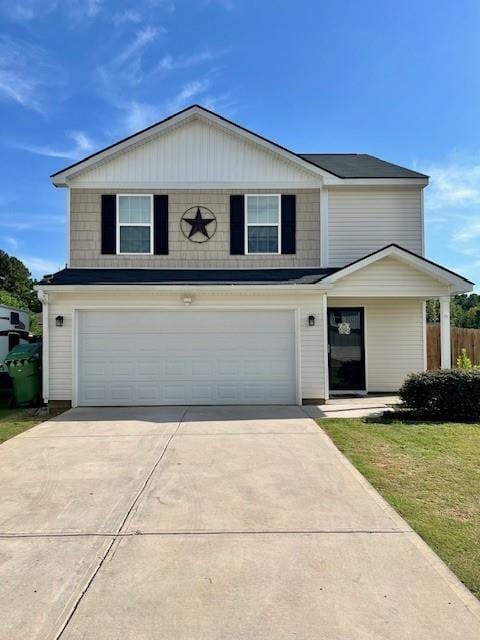 front of property featuring a garage and a front yard