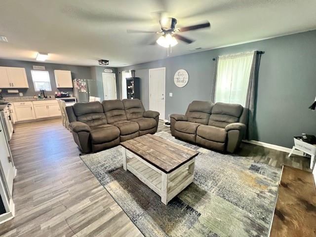 living room with sink, hardwood / wood-style floors, and ceiling fan