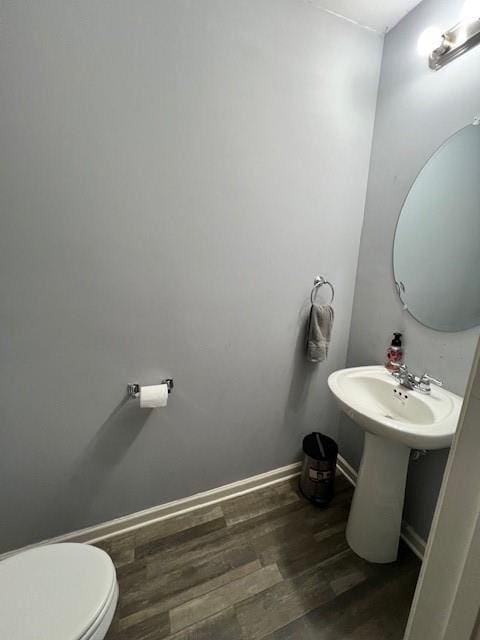 bathroom featuring hardwood / wood-style flooring and toilet