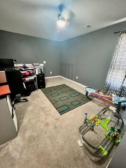 home office featuring carpet and ceiling fan