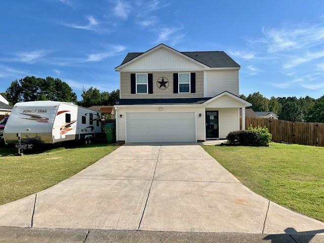 view of front facade with a garage and a front yard