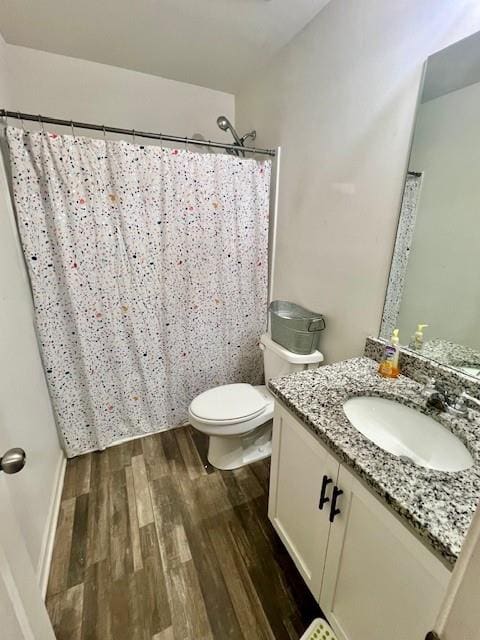 bathroom with hardwood / wood-style floors, vanity, and toilet