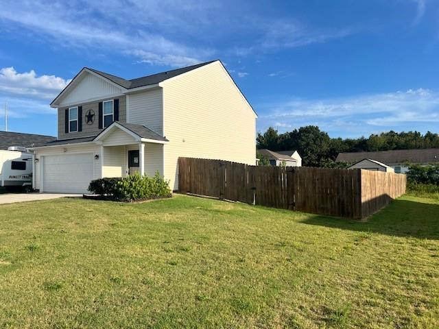 view of side of home featuring a garage and a yard