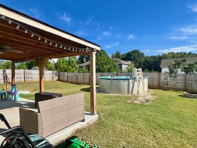 view of yard with a fenced in pool