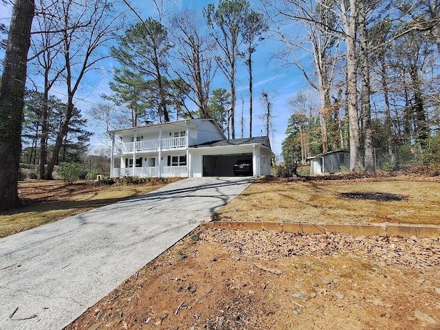 view of front facade with an attached carport, covered porch, and driveway