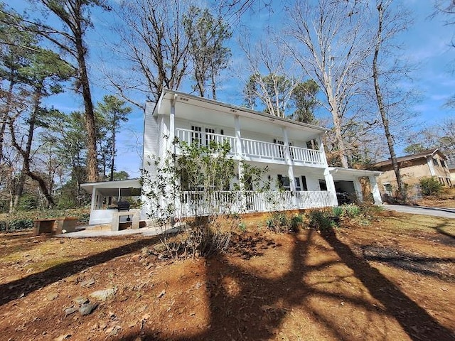 exterior space featuring an attached garage and a balcony