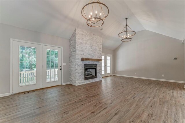 14 Brook Valley Ct SW, Rome, GA 30165 - unfurnished living room with a chandelier, wood finished floors, a fireplace, baseboards, and high vaulted ceiling