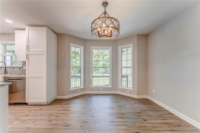 14 Brook Valley Ct SW, Rome, GA 30165 - unfurnished dining area featuring light wood-style floors, a chandelier, baseboards, a sink, and recessed lighting