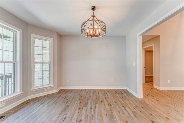 14 Brook Valley Ct SW, Rome, GA 30165 - spare room featuring light wood finished floors, plenty of natural light, a chandelier, and baseboards