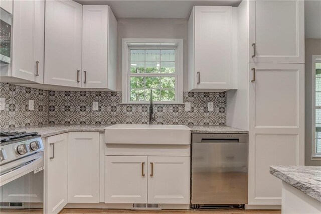 14 Brook Valley Ct SW, Rome, GA 30165 - kitchen featuring appliances with stainless steel finishes, a sink, white cabinetry, and backsplash