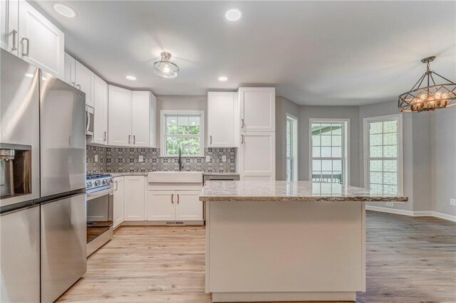 14 Brook Valley Ct SW, Rome, GA 30165 - kitchen with appliances with stainless steel finishes, a sink, light wood-style flooring, a chandelier, and recessed lighting