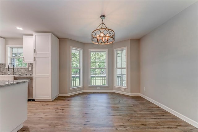 14 Brook Valley Ct SW, Rome, GA 30165 - unfurnished dining area featuring light wood-style floors, baseboards, a sink, and recessed lighting