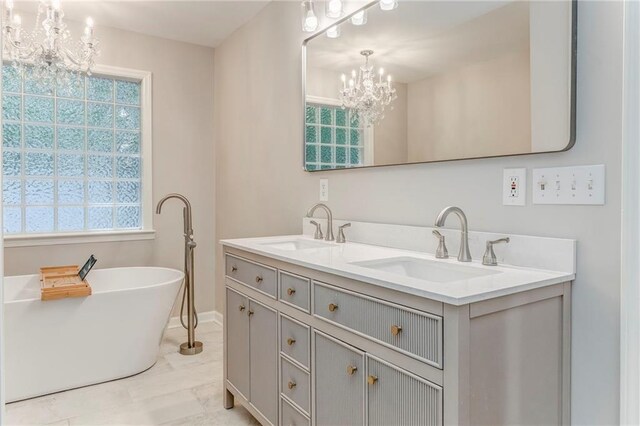 14 Brook Valley Ct SW, Rome, GA 30165 - full bathroom with a chandelier, double vanity, a freestanding bath, marble look tiles, and baseboards