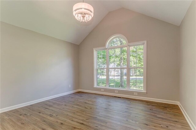 14 Brook Valley Ct SW, Rome, GA 30165 - empty room with a chandelier, lofted ceiling, wood finished floors, and baseboards
