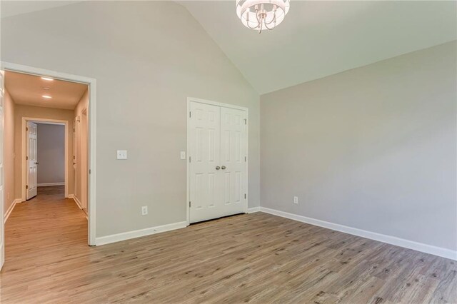 14 Brook Valley Ct SW, Rome, GA 30165 - unfurnished bedroom with high vaulted ceiling, light wood-style flooring, baseboards, and a closet